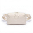 Zeeksack Crossbody Organizer i Sand White med ljusbeige axelrem och framficka.