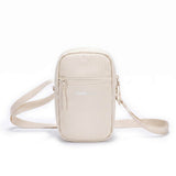 Zeeksack Travel Pouch i Sand White med ljusbeige axelrem och framficka.