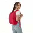 Kvinna med Zeeksack The Underseat 15L i Raspberry Red på ryggen.