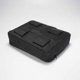 Svart packkub sedd underifrån med fyra kardborrefästen på undersidan.